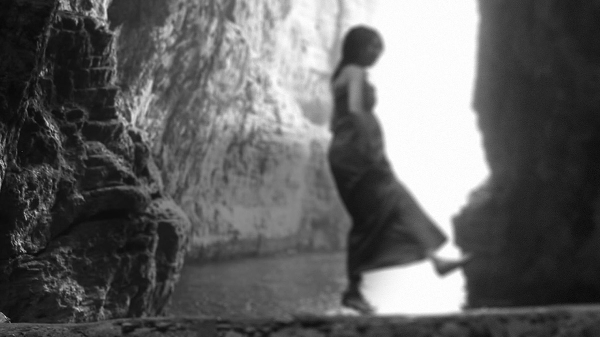 Woman Walking on Rocks in Italian Cave